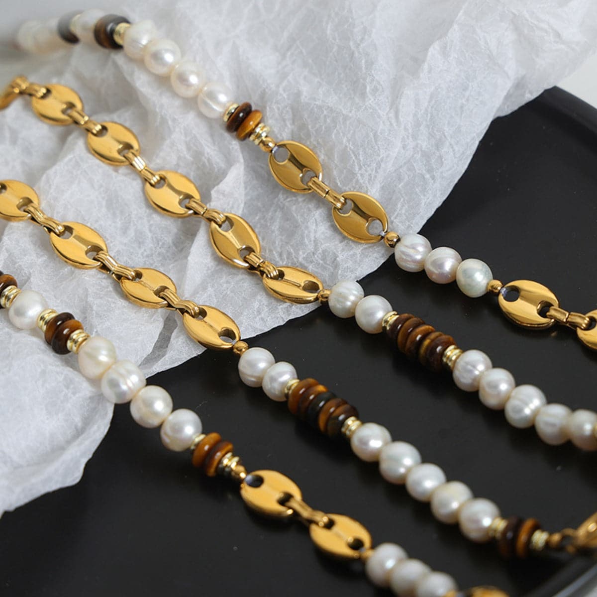 Elegante armband van titaniumstaal met 18K vergulding en parel