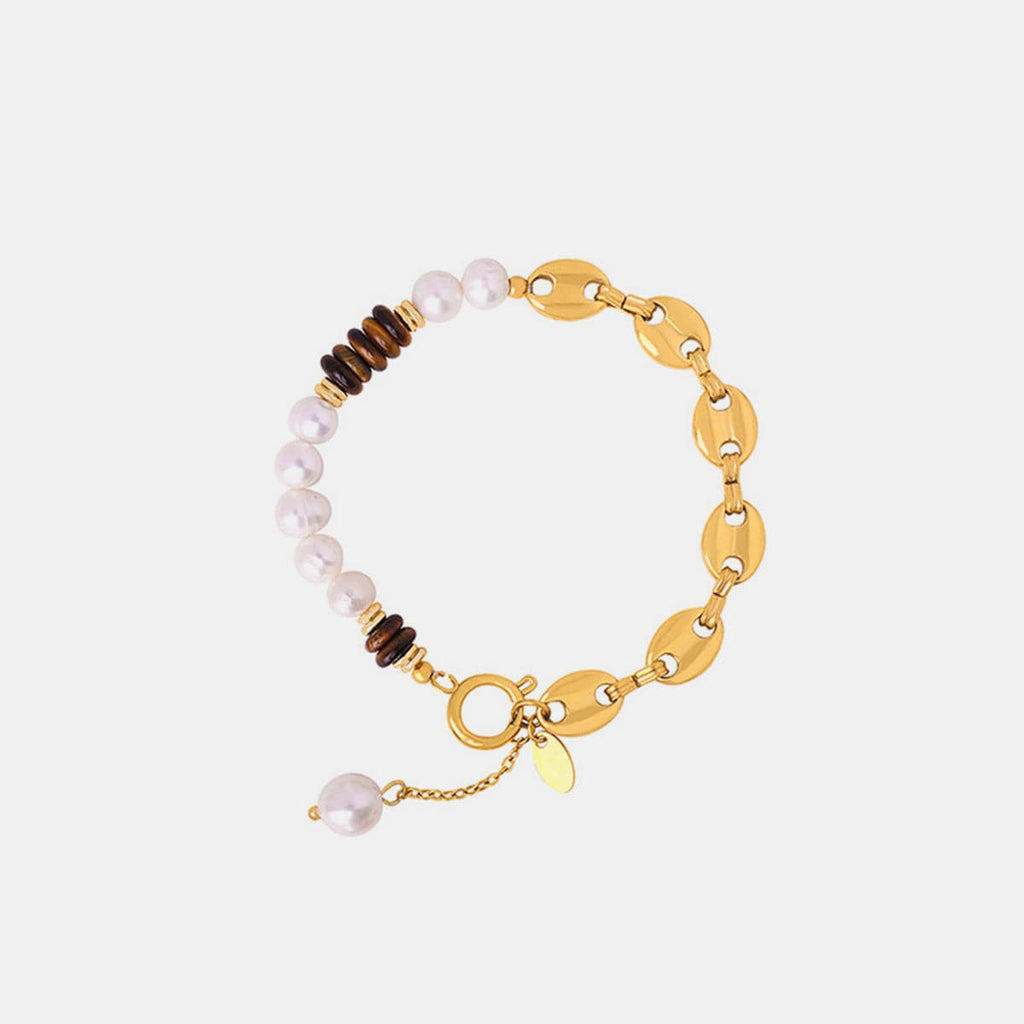 Elegante armband van titaniumstaal met 18K vergulding en parel